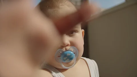 The boy looks at the camera close plan. sunny day Stock Footage 114612439