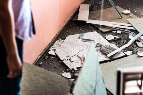 The boy looks at the destruction in the classroom. Stock Photos