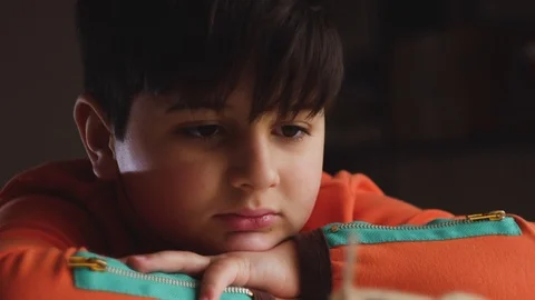 The boy looks at the model of the plane in front of him Stock Footage 88438445