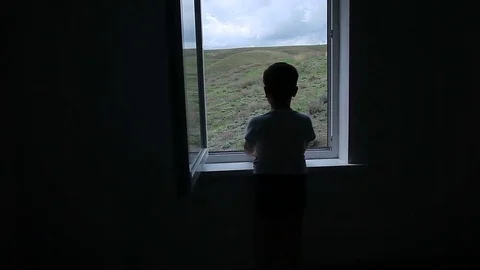 The boy looks at the open window on the sky Stock Footage 75558911