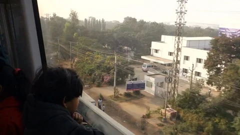 A boy looks outside through the window of Hyderabad Metro Stock Footage 83192007