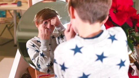 The boy looks at the round shape of his eye in the mirror, human anatomy. Stock Footage 144545115