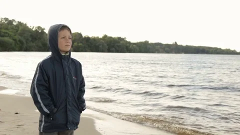 A boy looks at the sea, side view Video stock 76940844
