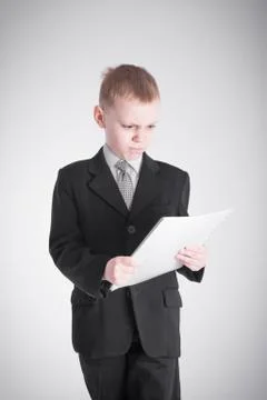 Boy looks at the stack of papers Stock Photos