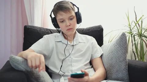 Boy Looks Surprised and Points At The Phone. Concept Shock Content Stock Footage 153325352
