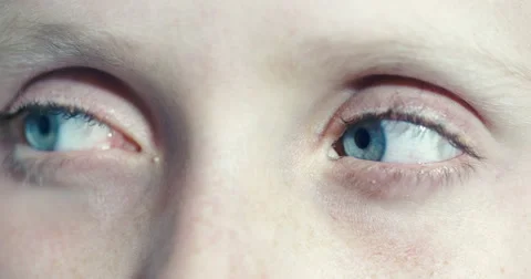 Boy looks suspiciously from side to side, turns to camera, frightened Stock Footage 54491095