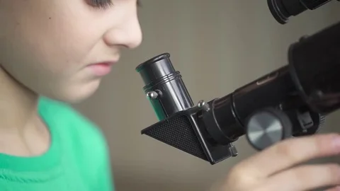 The Boy Looks in the Telescope Through an Open Window Stock-Footage 70066348