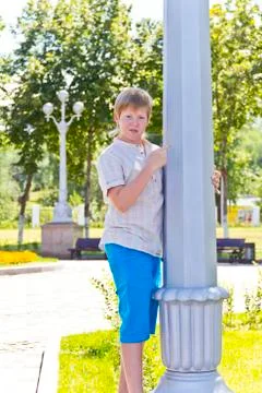 Boy looks at a white column Stock Photos