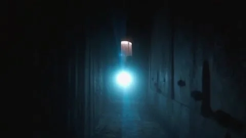 Boy lost with flashlights walking through dark tunnels Stock Footage 195764534