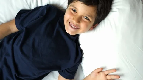 Boy lying and laughing Stock Footage 88908824