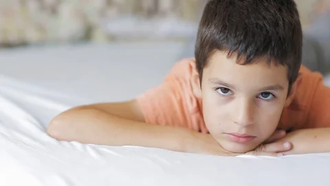 Boy lying on bed Stock Footage 112187815
