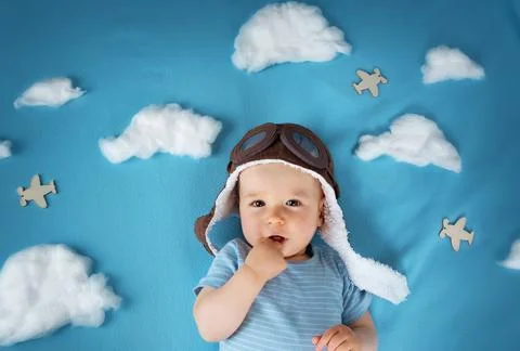 Boy lying on blanket with white clouds Stock Photos