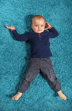 Boy lying on the carpet 2 스톡 사진