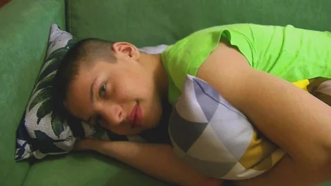 Boy is lying on the couch 2 Stock Footage 84849444