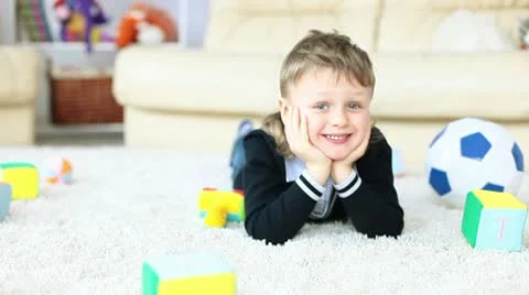 Boy lying on the floor and looking at camera 動画素材 10686892