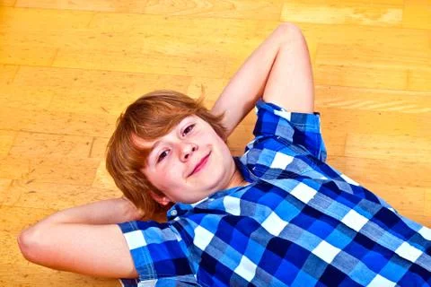 Boy lying at the floor Stock Photos