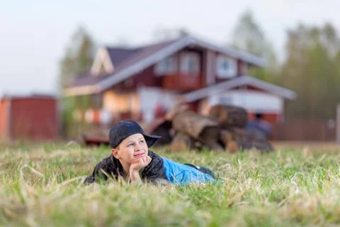 Boy lying on the grass Stock Photos
