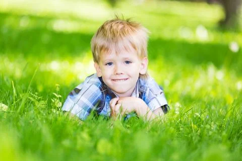 Boy lying in grass Stock Photos