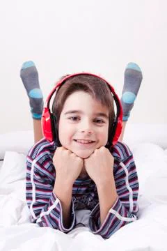 Boy lying with headphones Foto stock
