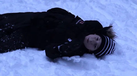 Boy lying in the snow, clown, winter Stock Footage 45604314
