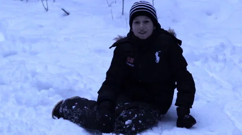Boy lying in the snow, clown, winter Video stock 45604328