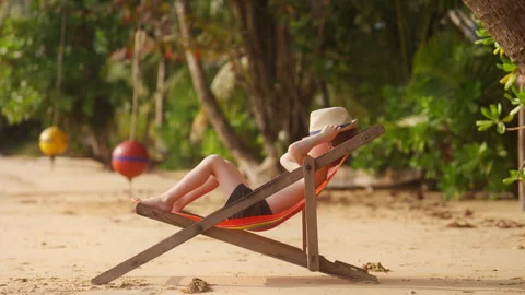 Boy Lying On Sun Lounger Resting Stock Footage 239192824