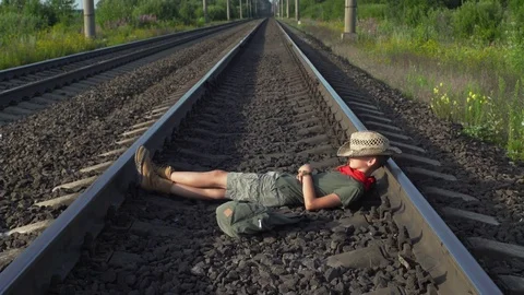 Boy Lying On Train Rails Stock Footage 79497561