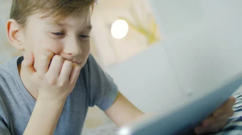 The boy made homework and now has a rest on a sofa Stock Footage 62066269