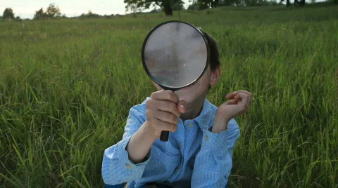 The boy with a magnifier 스톡 동영상 836906