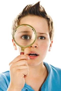 Boy with magnifier Stock Photos