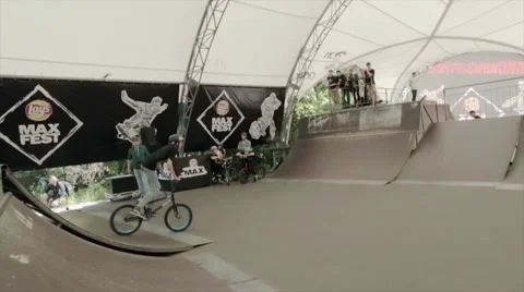 Boy make extreme trick on BMX bicycle in skate park and fall down. Slow motion Stock Footage 59857947