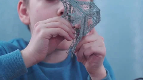 A boy makes a 3 d model with a pen. assembling the layout of the Elfin tower Stock Footage 146794180