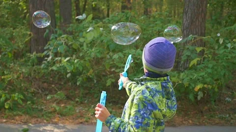 Boy makes big soap bubbles in the Park with delight 스톡 동영상 68202904