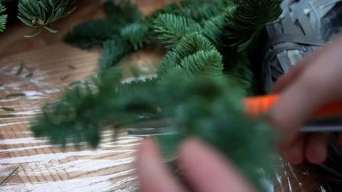 Boy makes christmas composition with fir-tree branches, close-up Stock-Footage 85284310