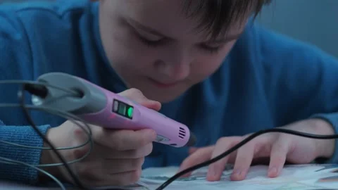 The boy makes a fake 3 d pen. development of children Stock Footage 147038018