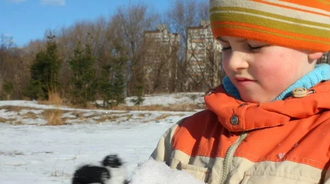 Boy makes snowball Stock Footage 374686