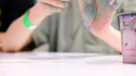 Boy making blue slime and kneading it in his hands, close-up Stock Footage 297102710