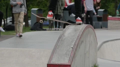 A boy making crooked grinde, jumping from a ledge with flip trick in a skate Stock Footage 63505264