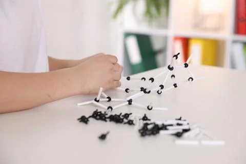 Boy making DNA structure model at desk indoors, closeup 스톡 사진