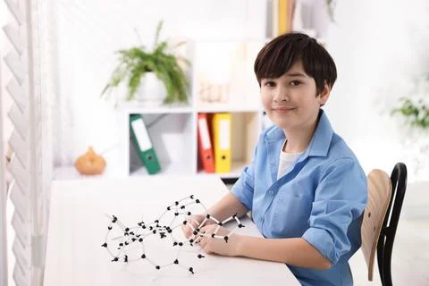 Boy making DNA structure model at desk indoors. Space for text 스톡 사진