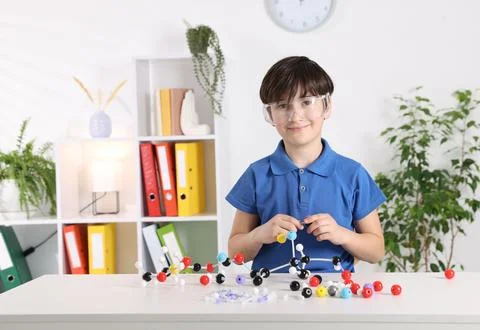 Boy making DNA structure model at desk indoors. Space for text 스톡 사진