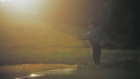Boy making drops splash with a stick Stock Footage 254005074