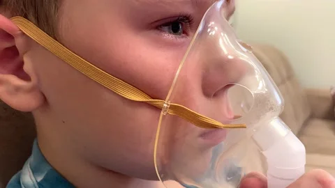 Boy making inhalation with nebulizer at home. Stock Footage 227511487