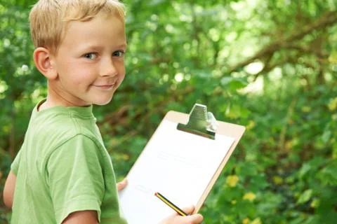 Boy Making Notes On School Nature Field Trip Stock Photos