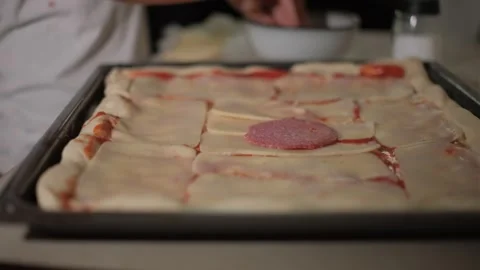 A boy is making pizza. Spreads tomato sauce. 스톡 동영상 281014133