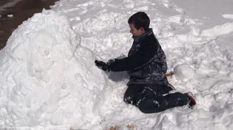 Boy making snowman Stock Footage 21444339