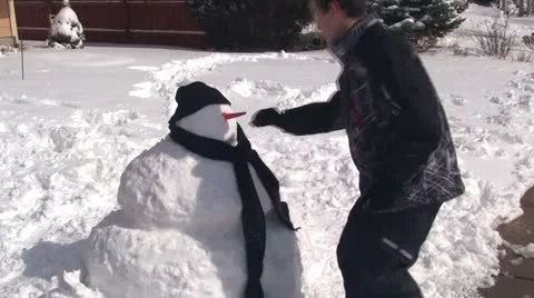 Boy making snowman Stock Footage 21444651