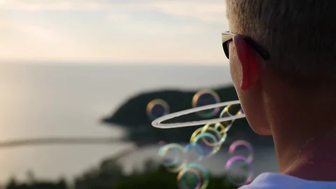 The boy is making soap bubbles. Close-up. Panoramic view Vidéo 74763380
