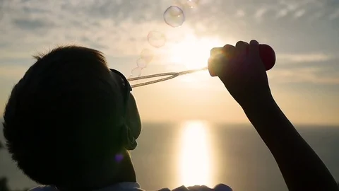 The boy is making soap bubbles. Closeup. Panoramic view 库存影片 74892301