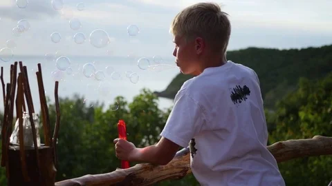 The boy is making soap bubbles. Panoramic view. Closeup 動画素材 75157544